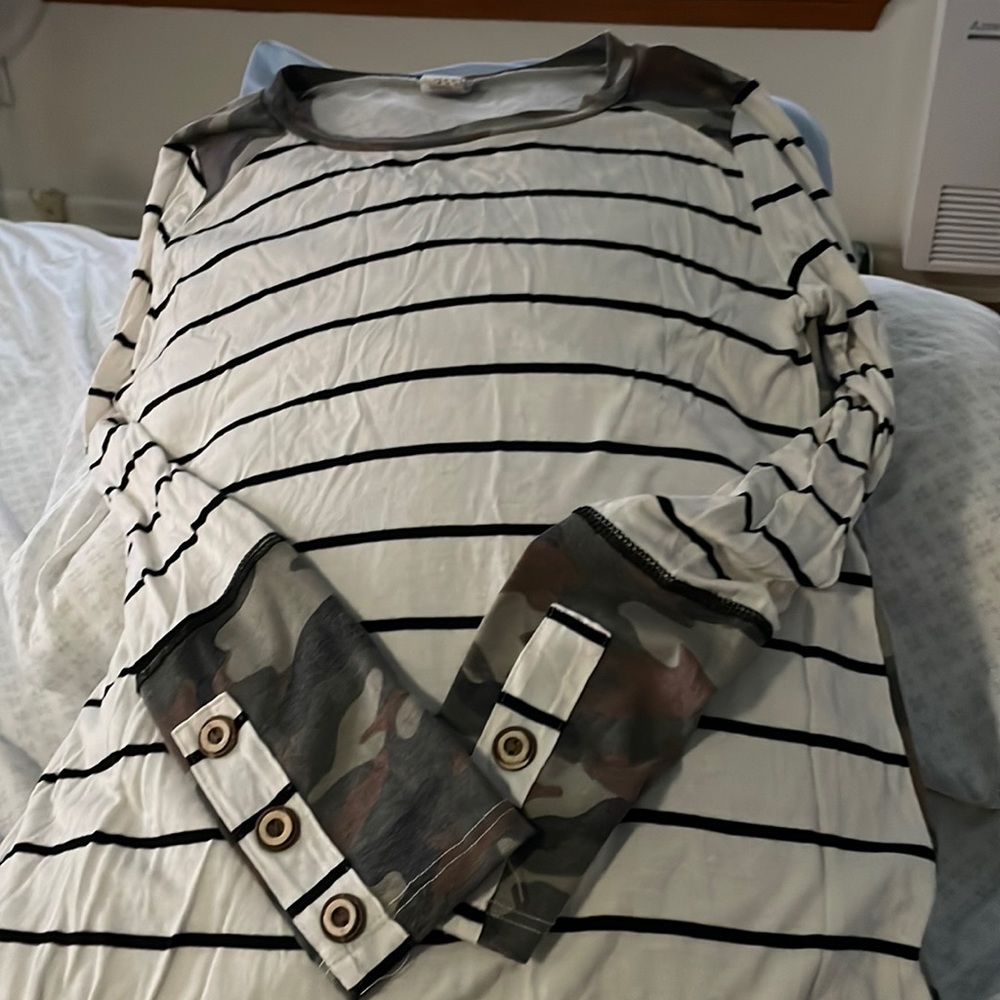 Striped front with cameo back . Cute button details on sleeve.